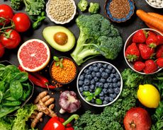 Fruit and vegetable superfoods laid across table