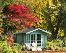 Summerhouse in garden surrounded by mature trees